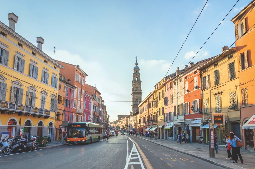 Colorful downtown Parma, Italy—a city famous for its prosciutto, cheese, architecture, and music Photo by Eddy Galeotti / Shutterstock