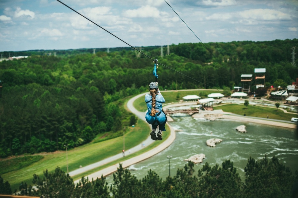 A girl going down the zip-line at The U.S. National Whitewater Center in Charlotte, North Carolina