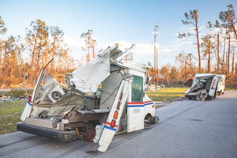 Two post office trucks that have been severely damaged from Hurricane Michael that hit the Panhandle of Florida