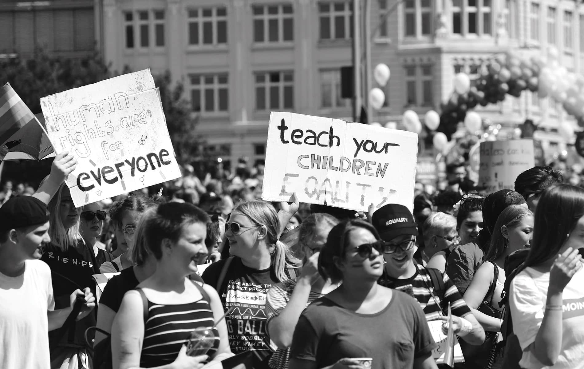 Black and white image of young people gather during an LGBTQ celebration and protest against discrimination on August 4, 2018, in Hamburg, Germany.