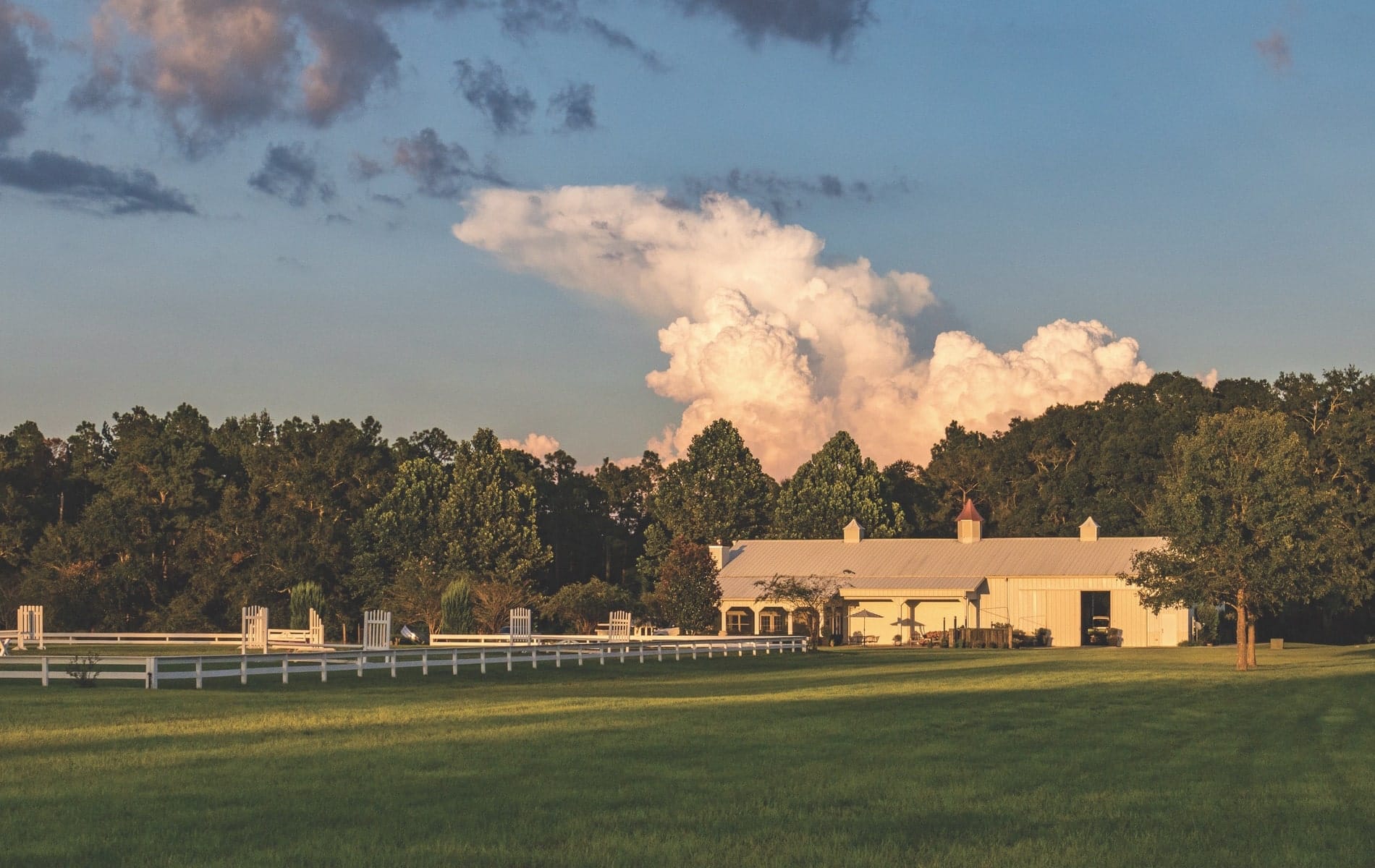 Architect Geoff Chick converted this beautiful barn in DeFuniak Springs, Florida, into a family home with connected stables and loft hangout space.