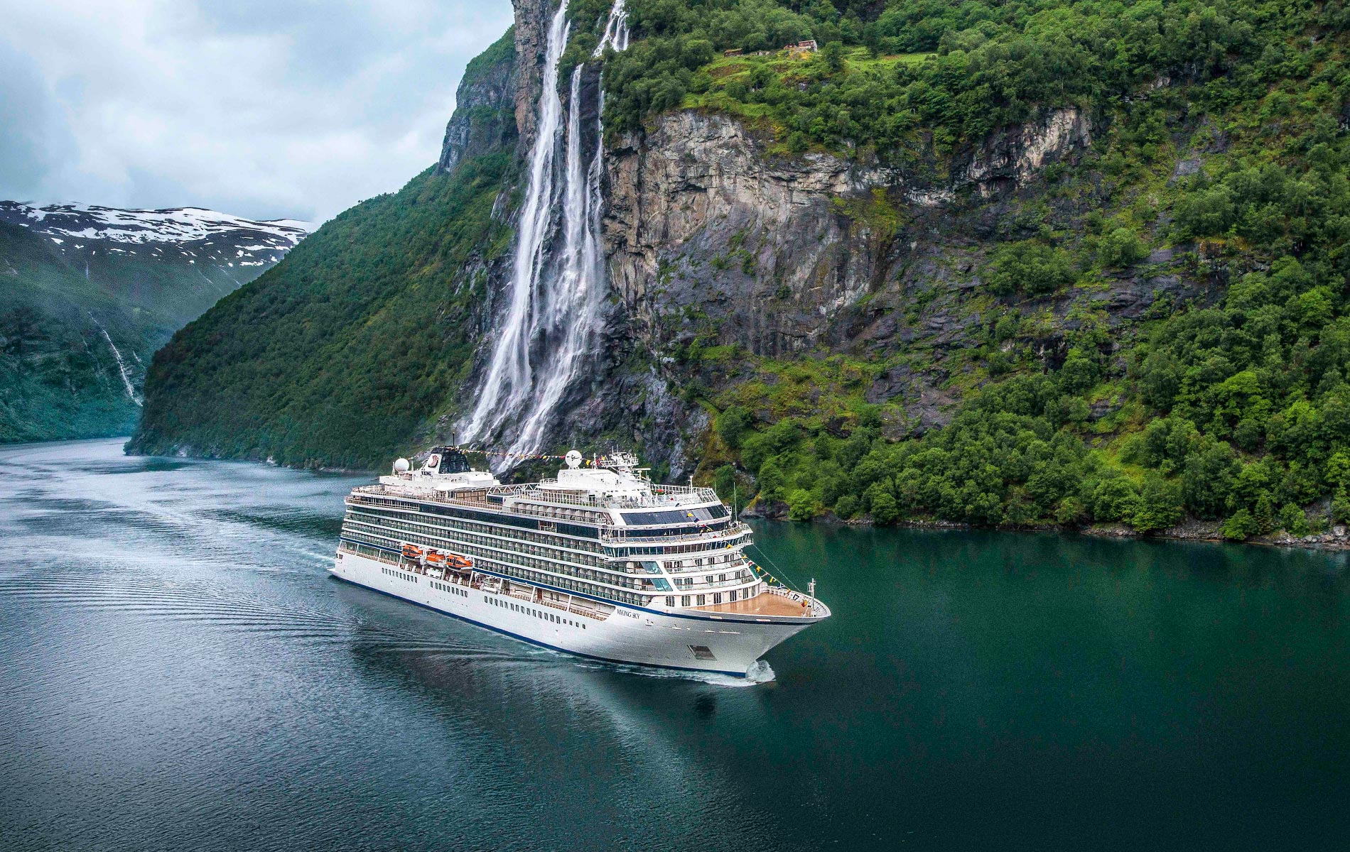 Viking Sky cruise ship, one of Viking Cruises luxury cruise liners, moving in the deep blue waters in between fjords outside of Sweden