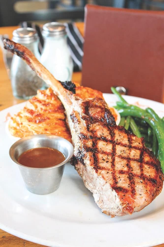 The bone-in pork chop at Ulele comes with guava demi-glace, twice-baked mashed potatoes, and seasonal veggies, Gonzmart Restaurant Group