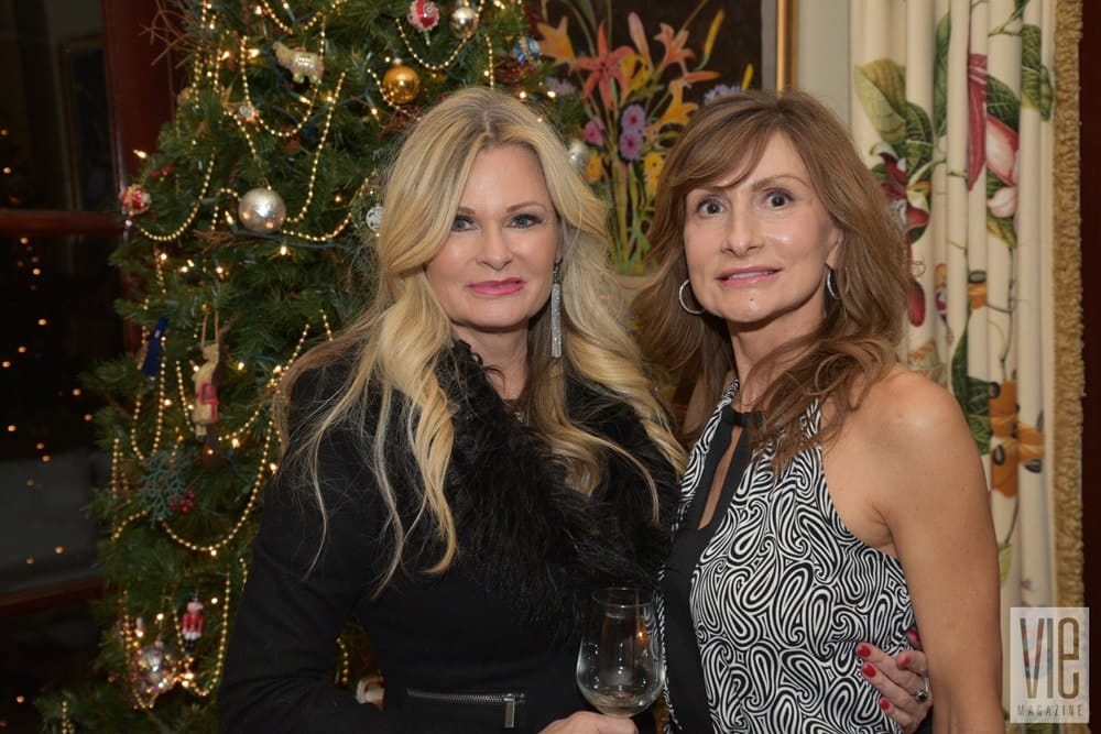 Lori Sweeney and Claire Nuckles attend Cafe Thirty-A's Christmas Charity Ball benefitting Caring and Sharing of South Walton, in Seagrove Beach, Florida on December 10, 2016