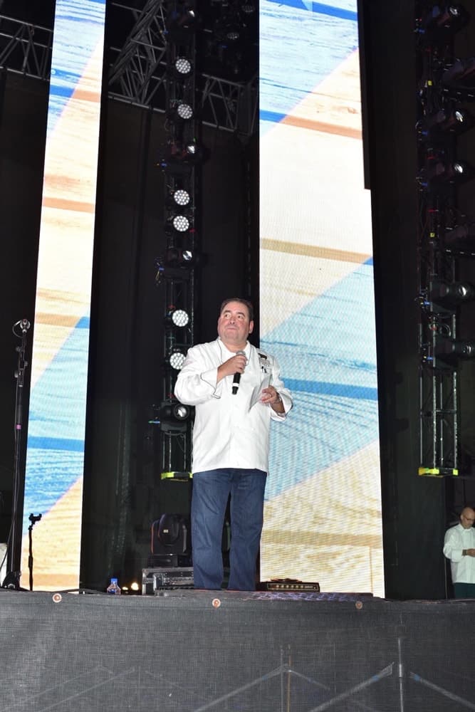 Emeril Lagasse speaking on stage at the Boudin Bourbon & Beer