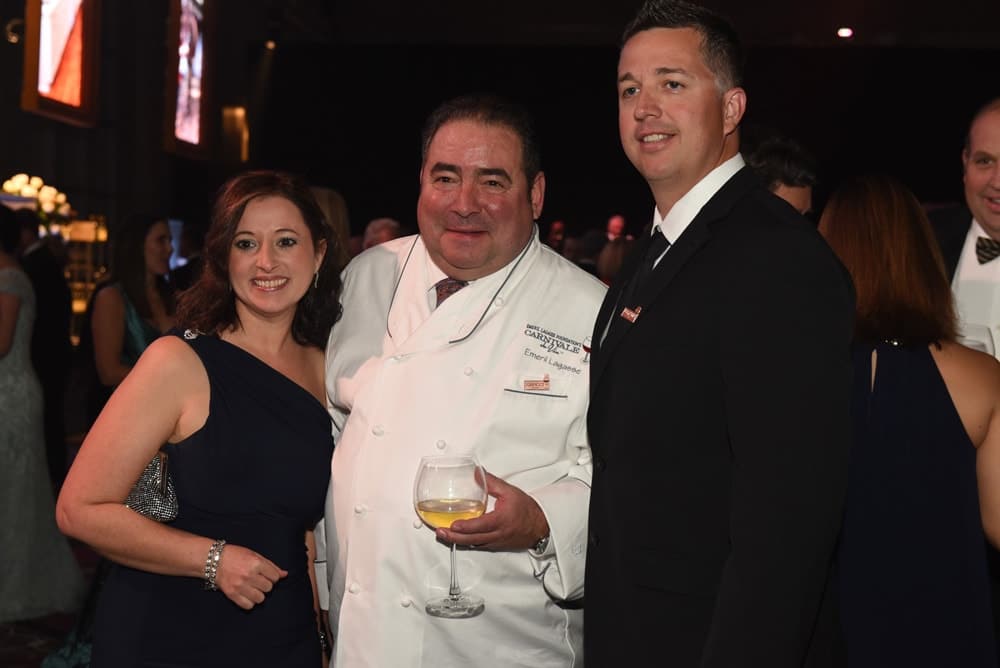 Emeril Lagasse speaks with guests at the Emeril Lagasse Foundation’ Carnivale du Vin gala and charity wine auction at the Hyatt Regency