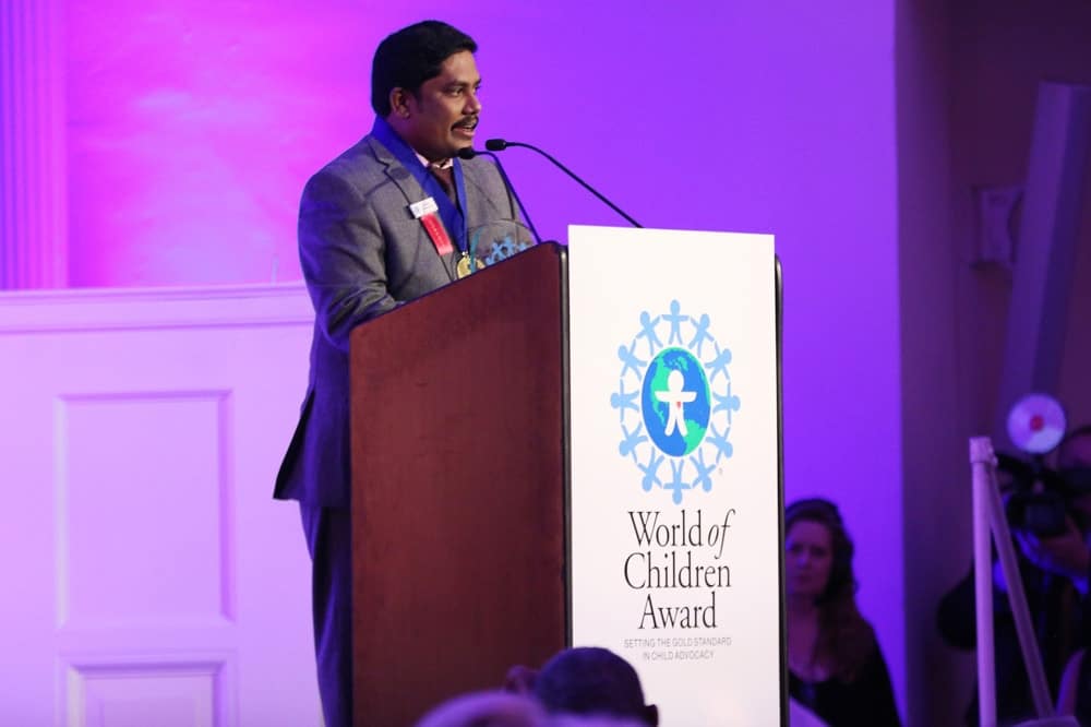 Honoree Iyyappan Subramaniyan speaks on stage during the World of Children Awards Ceremony