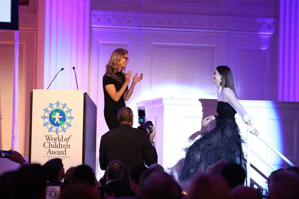 World of Children Award Board of Governors member Ann O'Malley and model Lily Aldridge Followill appear on stage during the World of Children Awards Ceremony