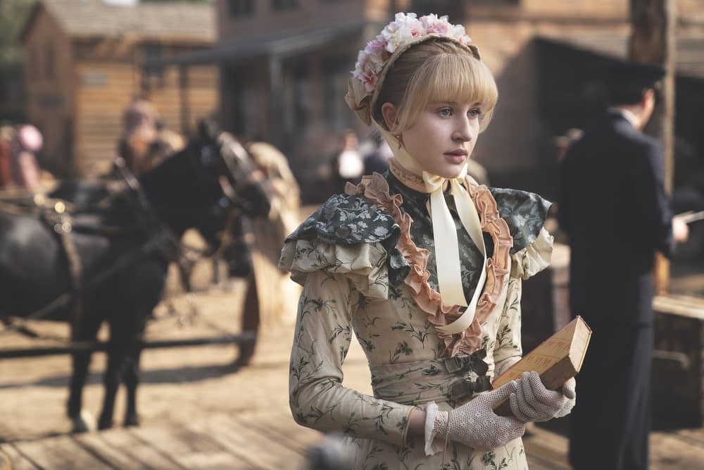 Lily Keene as Sofia Metz in Deadwood wearing an elaborate 1800s-inspired costume design by Janie Bryant