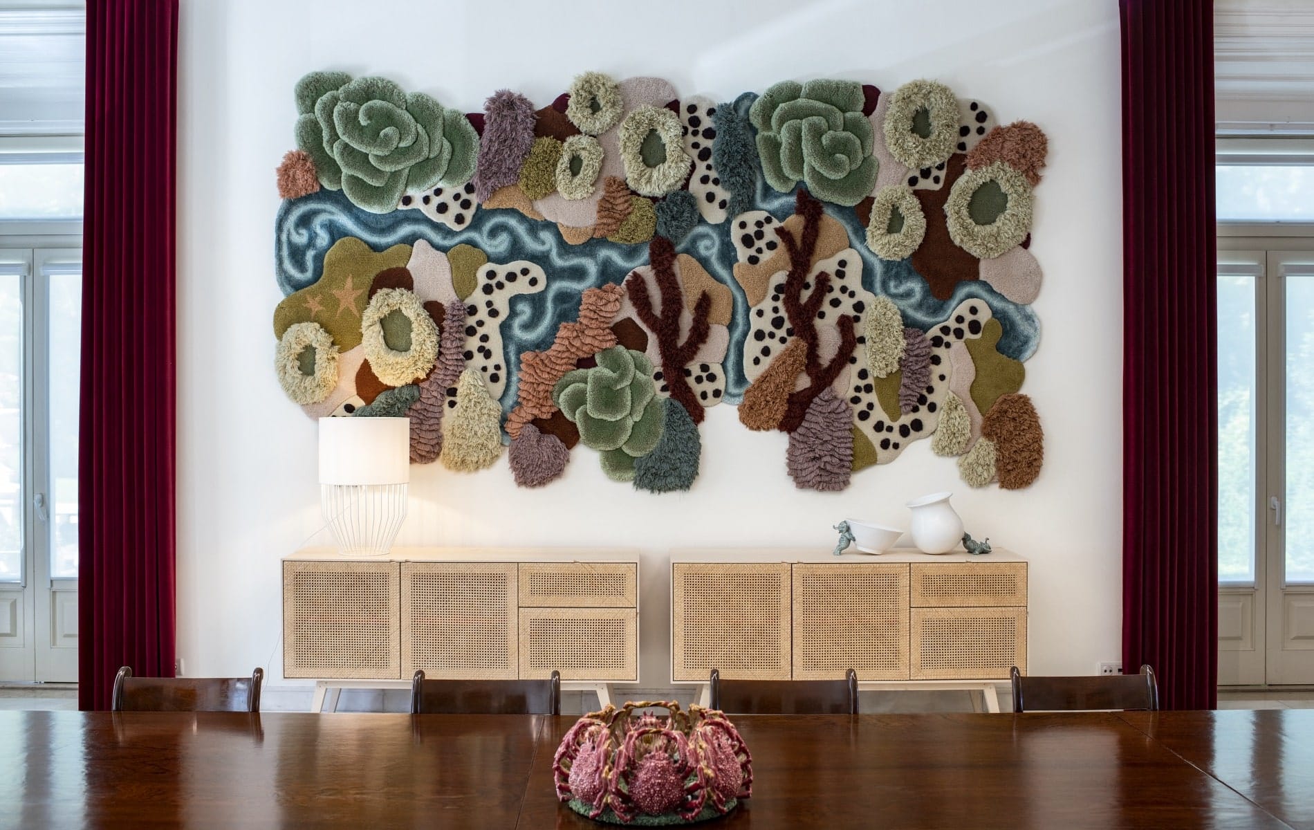 Vanessa Barragao tapestry hangs in a dining room