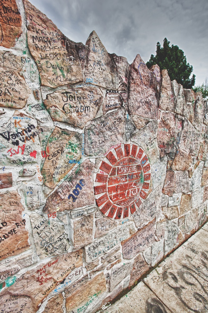 The wall surrounding Graceland Mansion. Here, hundreds of thousands of fans have written messages to Elvis over the years