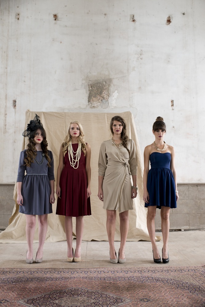 From left to right: The McKenzie Dress, the Jackie Dress in burgundy, the Helene wrap in champagne silk crepe de chine, and the Ava Dress in navy silk crepe de chine