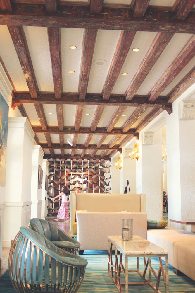 Original hand-stenciled pecky cypress ceiling beams above one of many cozy nooks in the Vinoy's grand lobby
