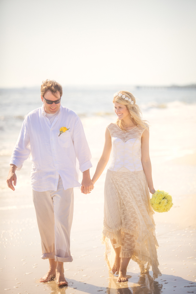 Bride and groom walking along beach at Mexico Beach wedding photo shoot, photos by Romona Robbins