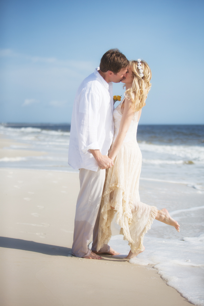 Bride and groom kissing on beach at Mexico Beach wedding photo shoot, photos by Romona Robbins