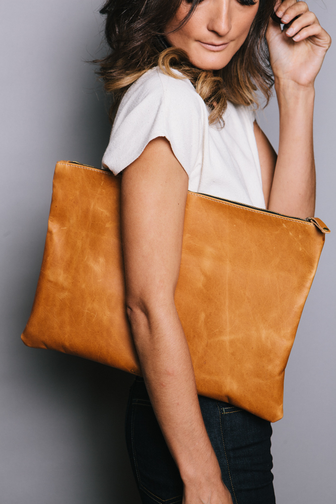 Model Display Of An Oversized Ceri Hoover Cognac Colored Clutch