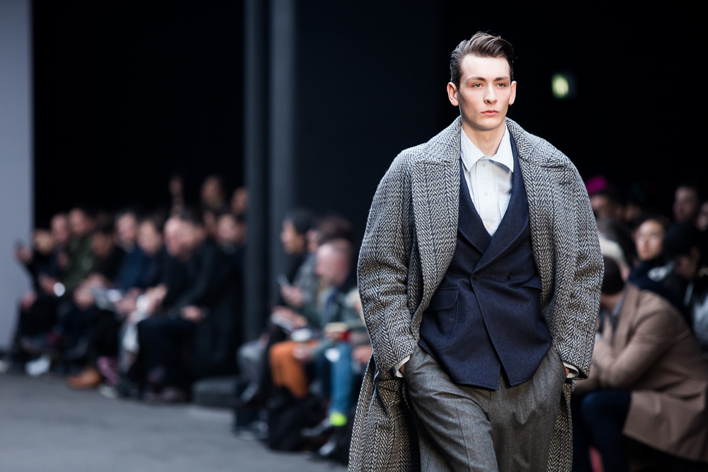 Male model walking down London's Fall Winter 2015 in jacket