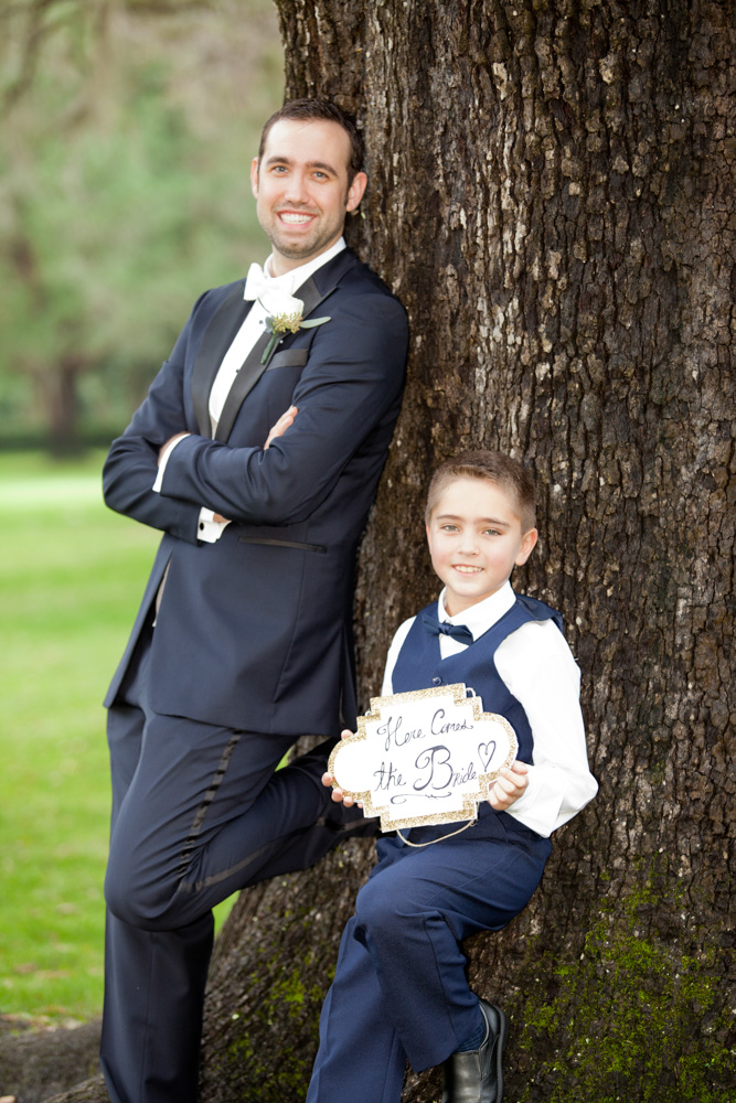 Groom and little boy holding flowers