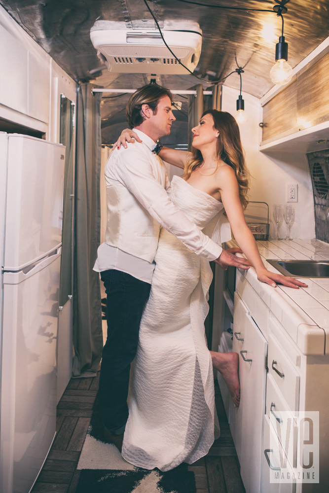 Groom and bride in airstream kitchen