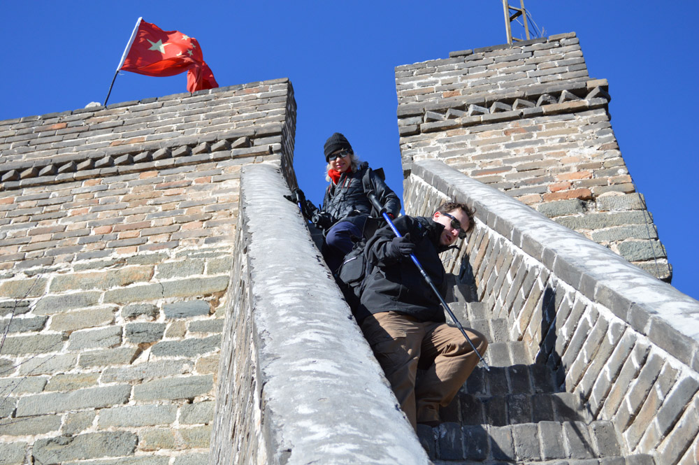 Couple climbing stairs on the Great Wall of China