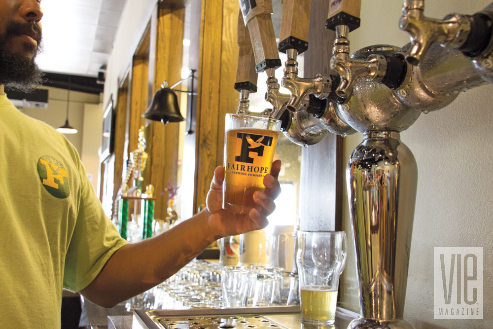 Pouring beer from a tap at Fairhope Brewing Company in Alabama