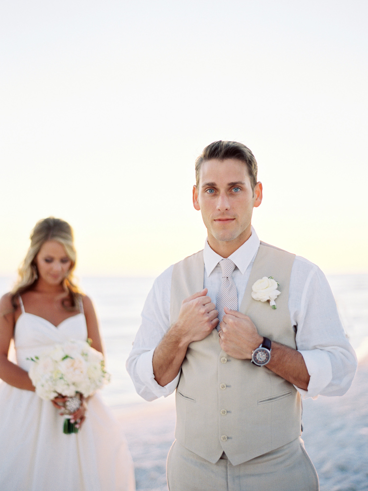 Bride and groom, Jennifer and Jimmy Goff, posing on the beach