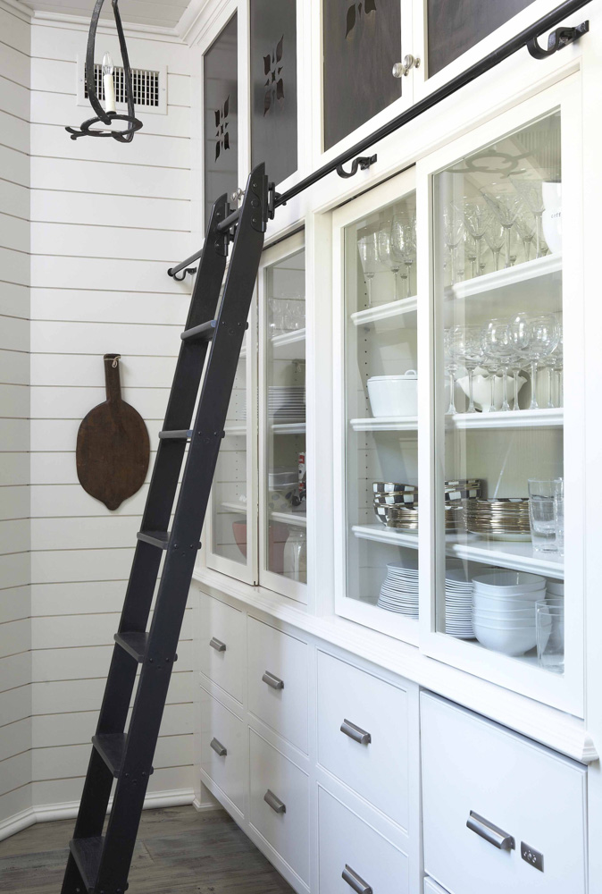 White cabinets with black sliding ladder
