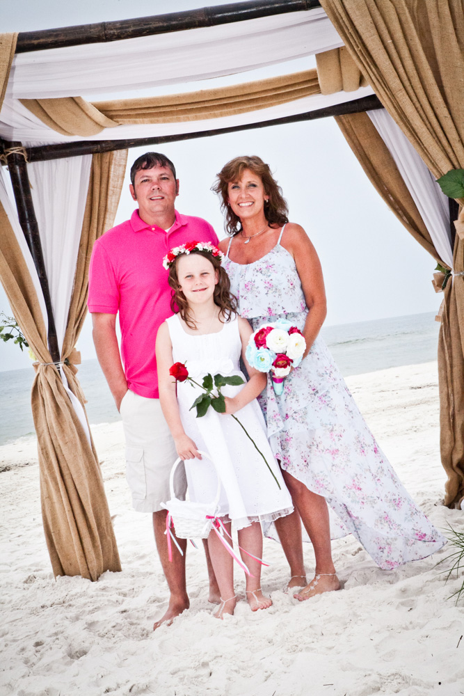 Family stand under beach alter