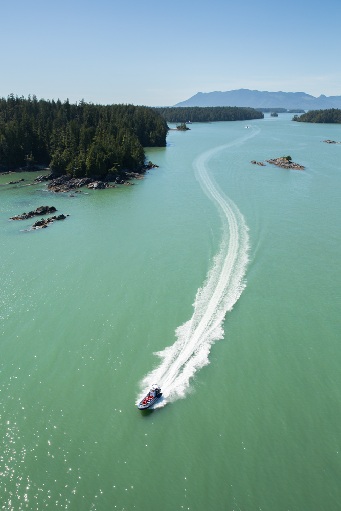 Aerial view of a boat jetting across blue green waters near Vancouver Island, Canada