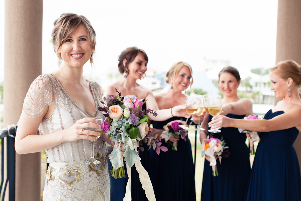 Wedding Event Specialists bride and bridesmaids toasting on the balcony. Photo by Mad Love Weddings