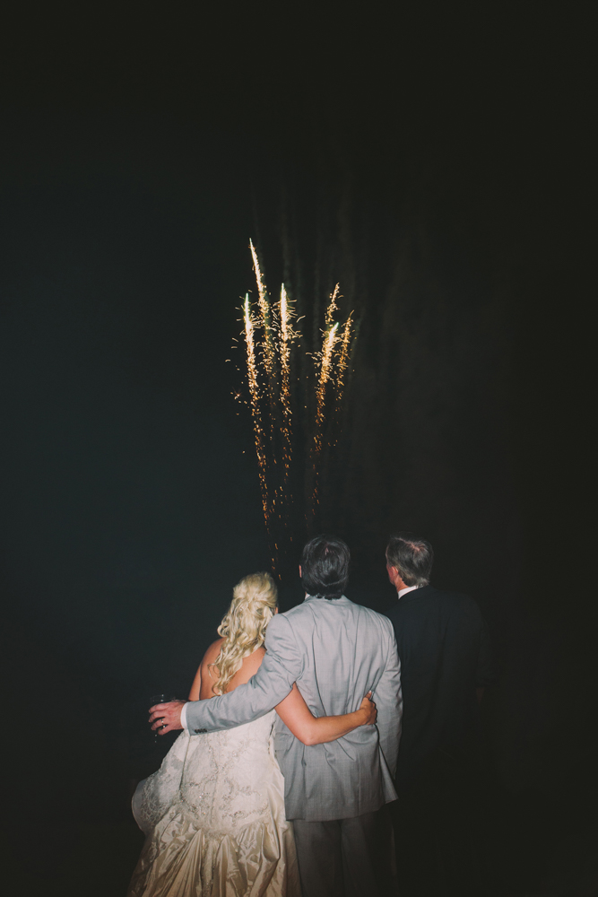 Bride and groom watching fireworks at Kimberly and Clain Zimmerman beach wedding