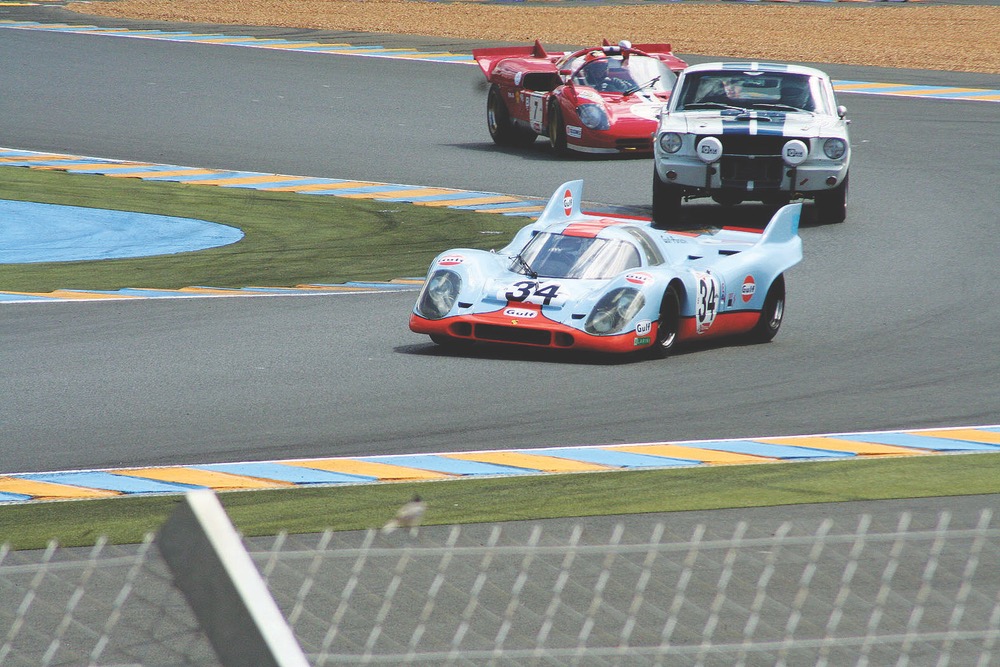 A 1970 Ferrari 512 S with a 1966 Shelby Mustang GT350 and a 1971 Porsche 917 in hot pursuit