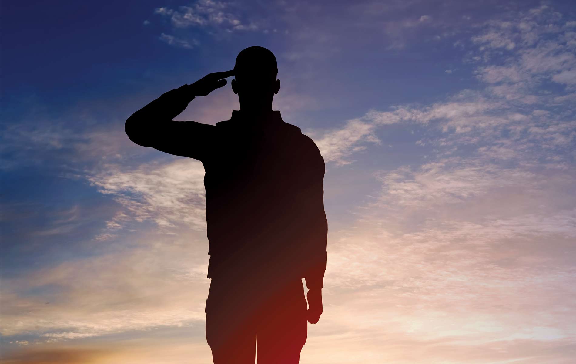 Soldier saluting in the sunset