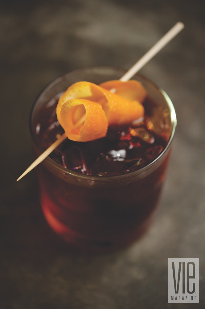 Borago's Chilled Red Cocktail With A Spiraled Orange Zest As A Garnish