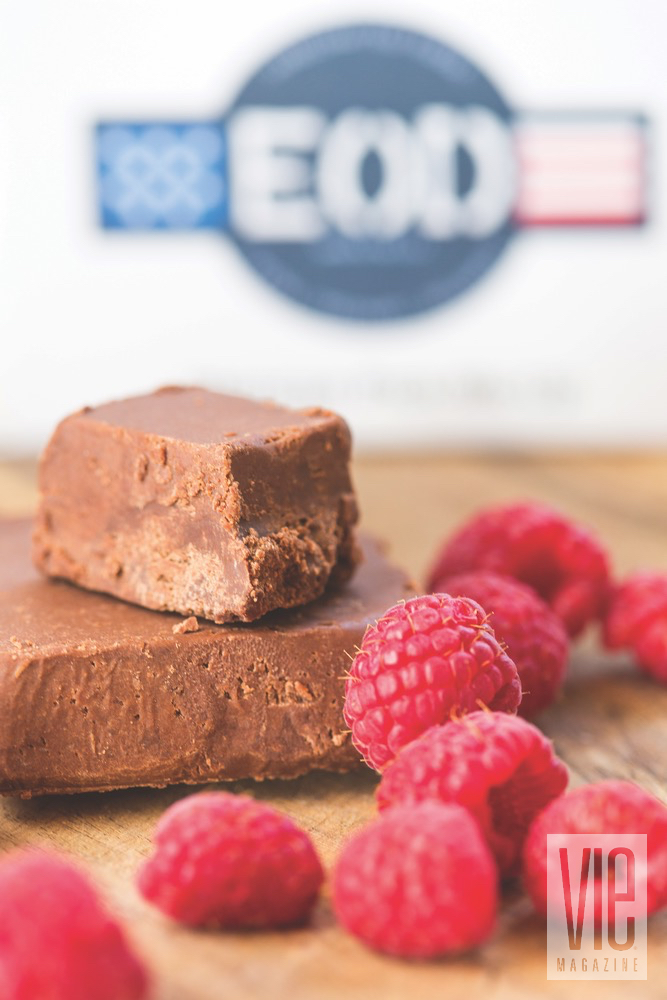 A Couple Bars Of EOD Chocolate Fudge With A Handful Of Raspberries