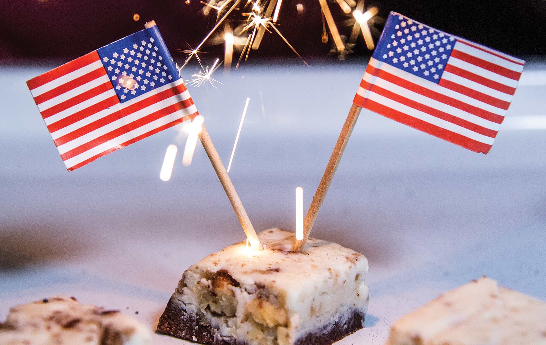 Cookies And Cream EOD Fudge With Two Mirrored American Flags And A Sparkler Background