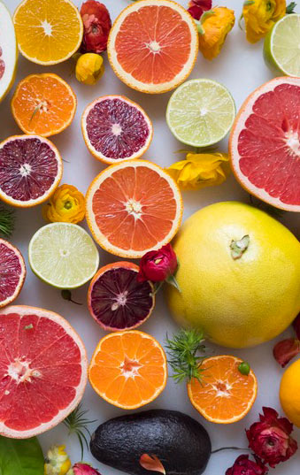 A Photograph Of Citrus Fruit Dominant Of Sherbet Orange And Grapefruit Pink With Accents Of Lemon Yellow to Lime Green 