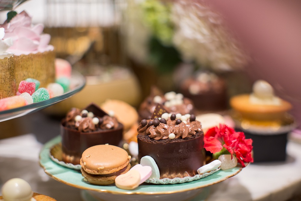 Photograph Of Decadent Chocolate Desserts By Romona Robbins Garnished With A Cherry Red Carnation