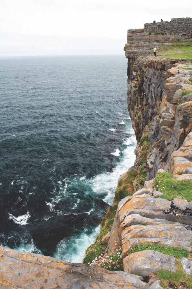 Beatuiful View Of A Rocky Cliff Hovering Over The Deep Dark Blue Sea