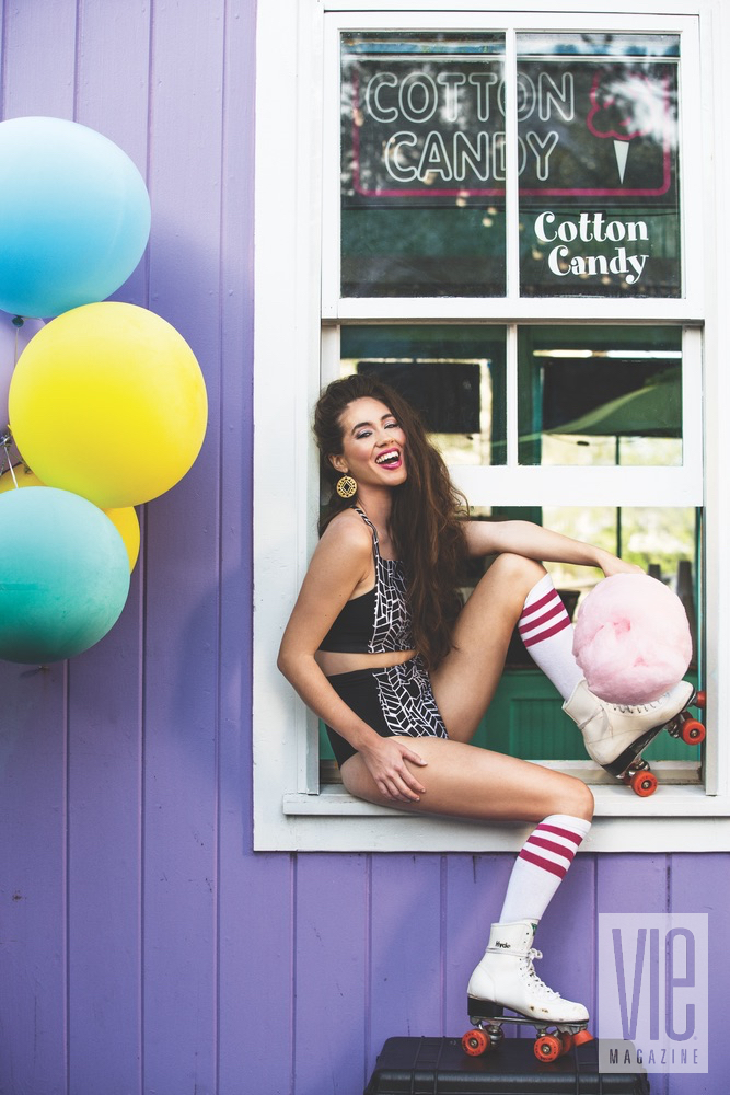 Gorgeous model Piper Williams eating cotton candy and wearing roller blades