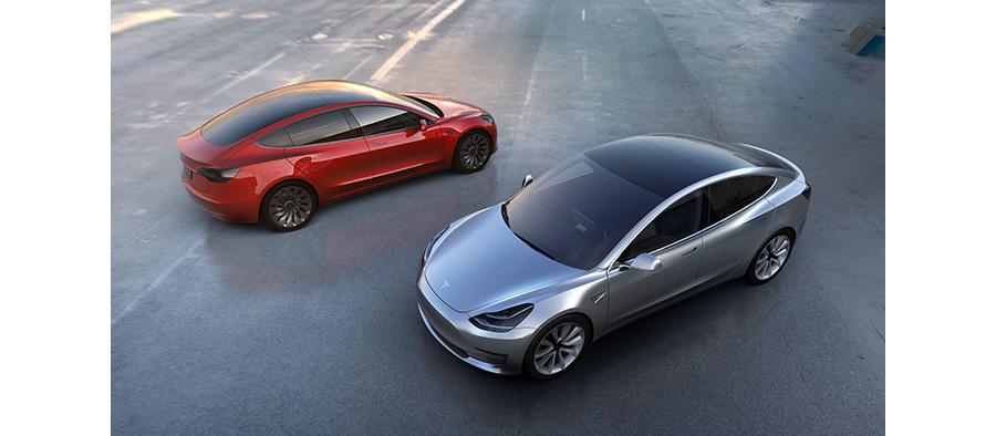 Red and Pewter Colored Tesla 3 Electric Cars Side By Side