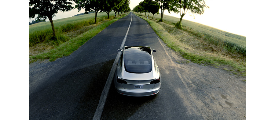 Electric Car Tesla 3 Cruising Down The Street