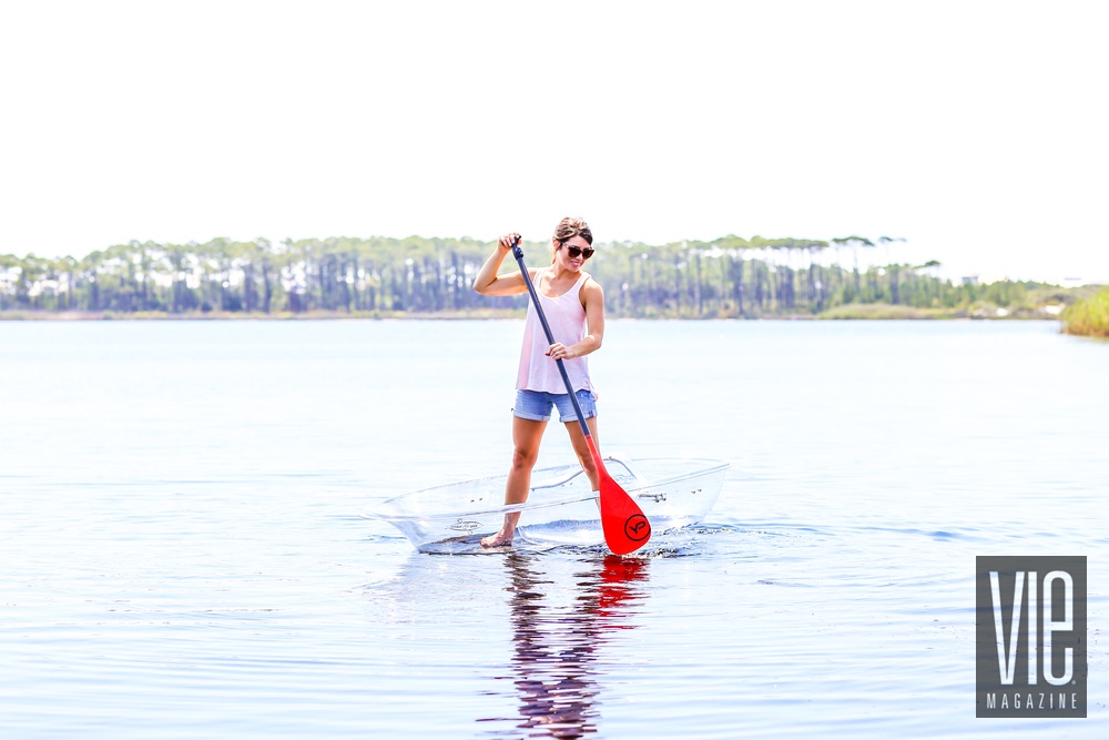 Model standup paddleboarding in a Klear Kanoo on Western Lake