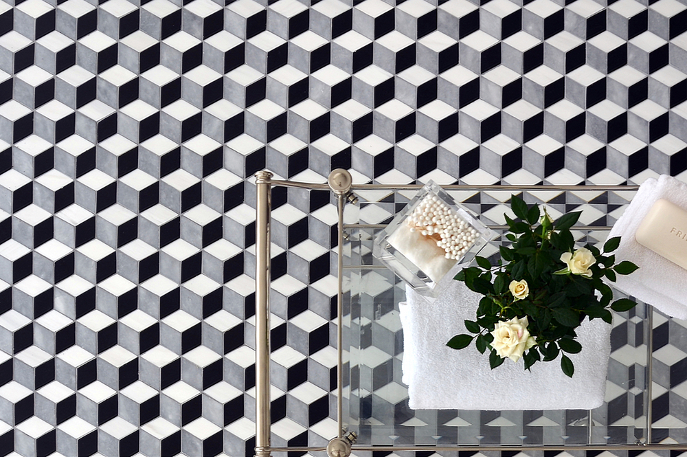 Euclid, a waterjet mosaic shown in honed Chinese Black, honed Allure, and polished Dolomite, is part of the Illusionsô Collection by Sara Baldwin Designs for New Ravenna.