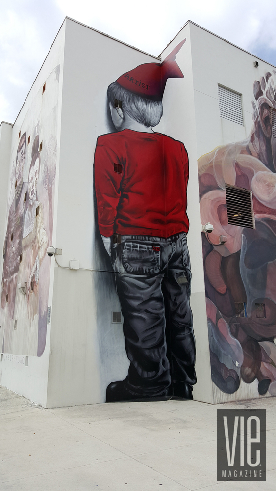 Mural painting on side of wall Wynwood Walls Miami Florida grafitti street art boy corner