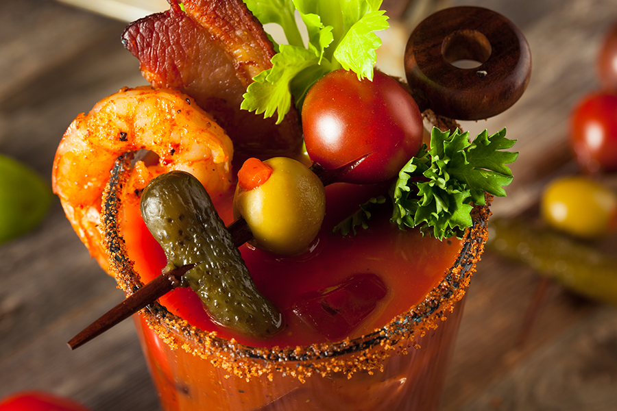 Bloody Mary garnished with shrimp cocktail bacon and olives