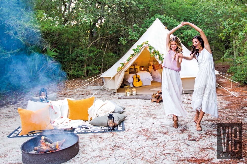 Models laughing and dancing outside of their Fancy Camps tent glamping