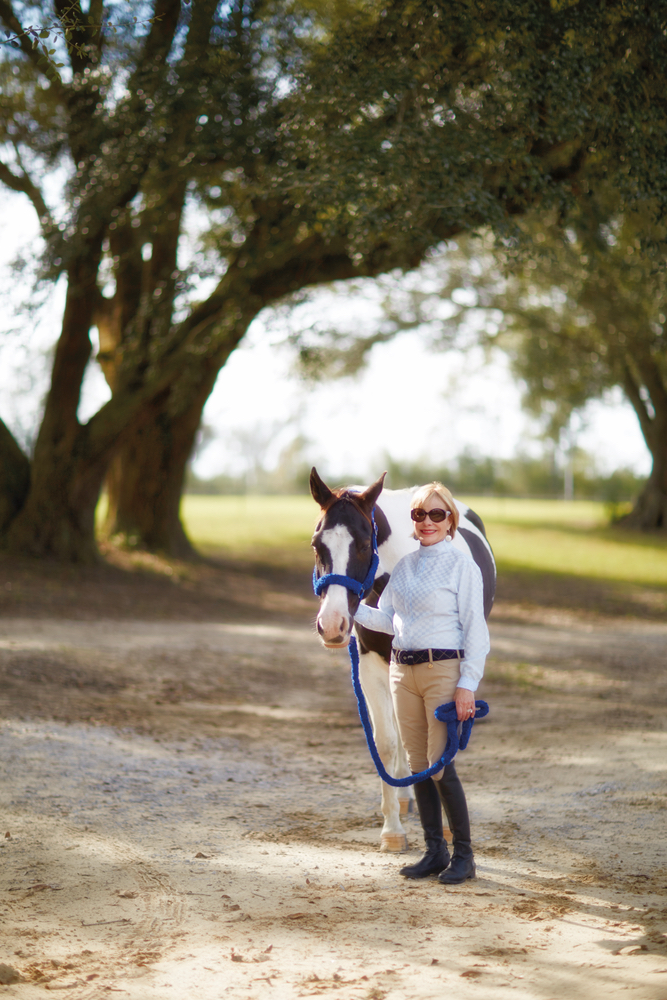 Susan Lovelace with her horse at her farmhouse interior design 