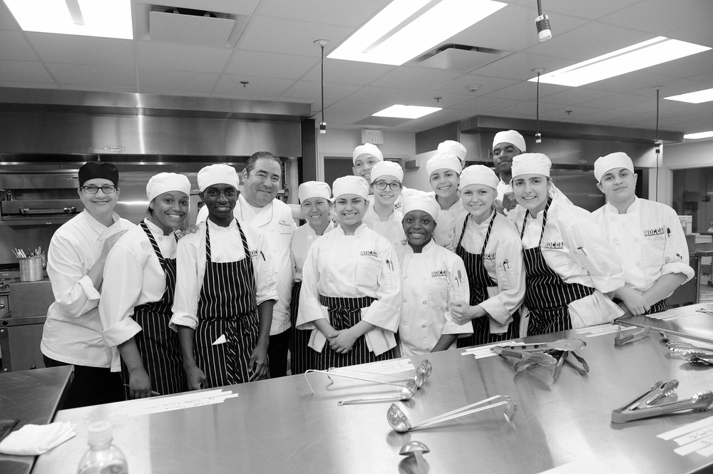 Chef Emeril and students participate in a kitchen training program supported by the Emeril Lagasse Foundation.