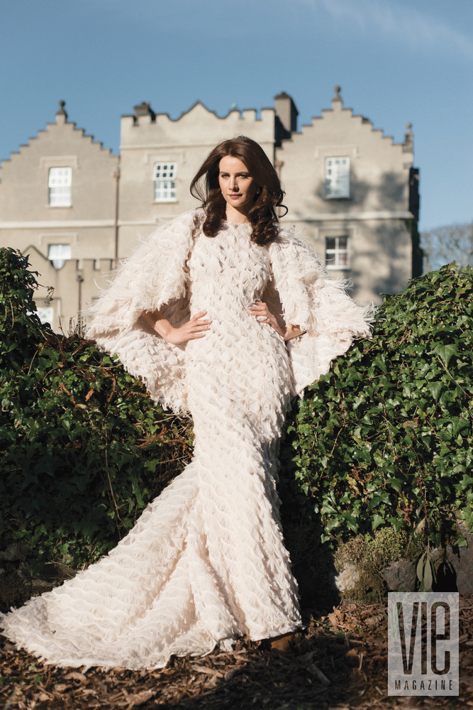 Irish model Faye Dinsmore standing in front of Ballynahinch Castle in Christian Siriano gown